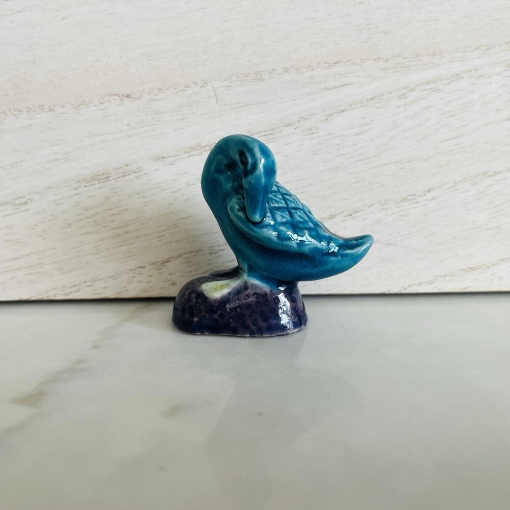 Miniature Duck Figurine Ceramic sitting on rock Made In China, teal blue glazed